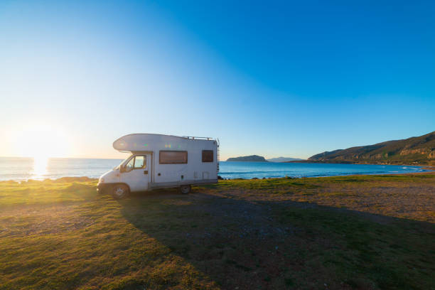 istock Coastal sunset with recreational vehicle, Motorhome parked by the seaside under a dramatic sunset sky 2176403791