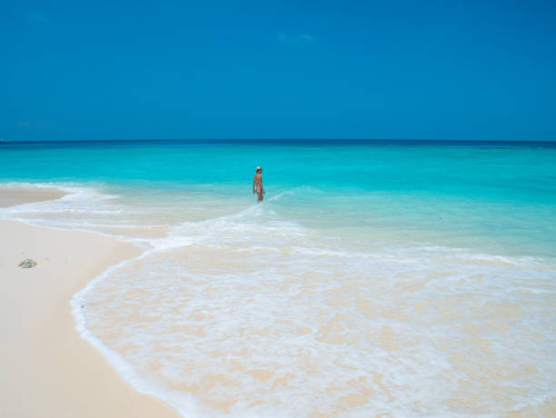 istock Serene tropical getaway woman relaxing in clear blue waters 2176403797