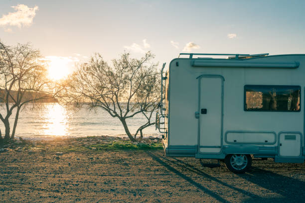 istock Coastal sunset with recreational vehicle, Motorhome parked by the seaside under a dramatic sunset sky 2176403811