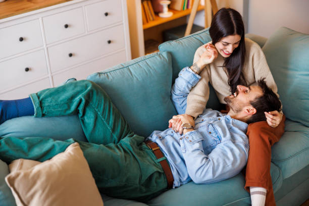 istock Loving couple cuddling and relaxing at home 2176407743