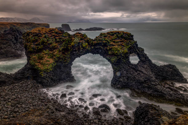 istock rocky shore with a surf with foam on the water 2176408076