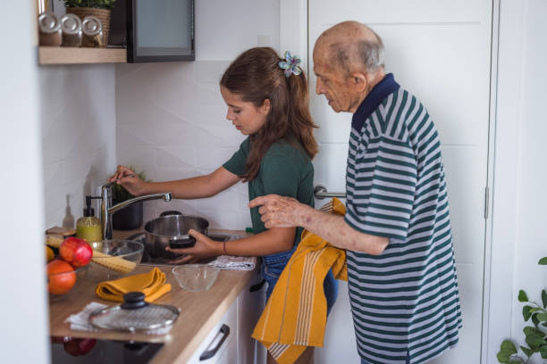 istock Granddad observing girl preparing bowl for cooking lunch 2176408362