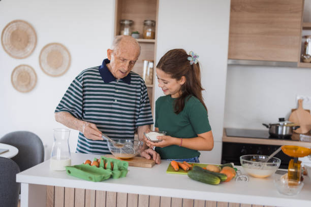 istock Girl assisting grandad with breakfast 2176408378