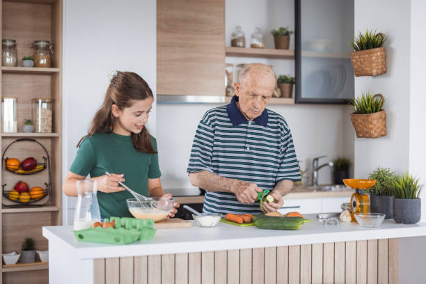 istock Senior man peeling the vegetables and assisting in preparing lunch 2176408452