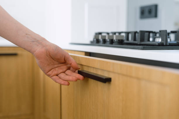 istock Woman open or closed drawer on modern wooden kitchen 2176414116