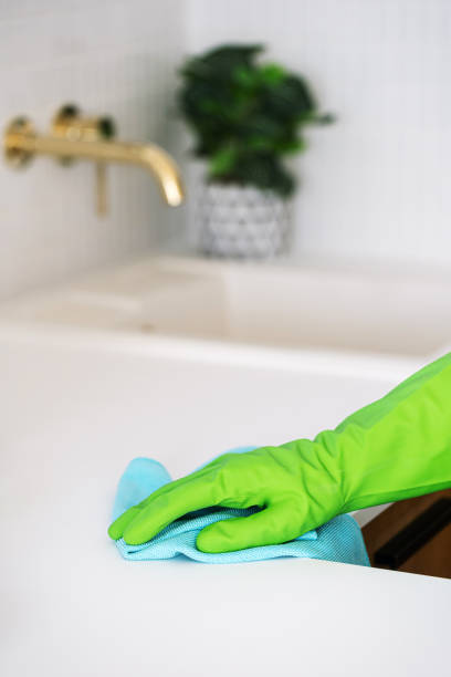 istock A person cleans a countertop in a modern kitchen interior 2176414167