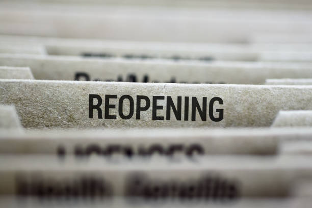 istock Close view of file folder labeled 'Reopening' in focus 2176415473