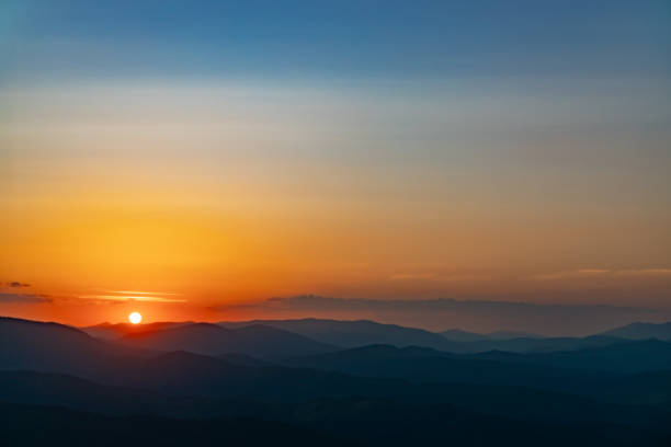 Sunset on the top of the mountain, mountain peaks on the background of the mountain landscape.