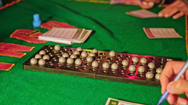 istock Bingo Game Croupier Putting Number Ball on Display on Plastic Tray 2176417559