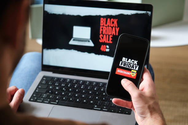 istock Man using laptop and smartphone for black friday shopping online 2176419086