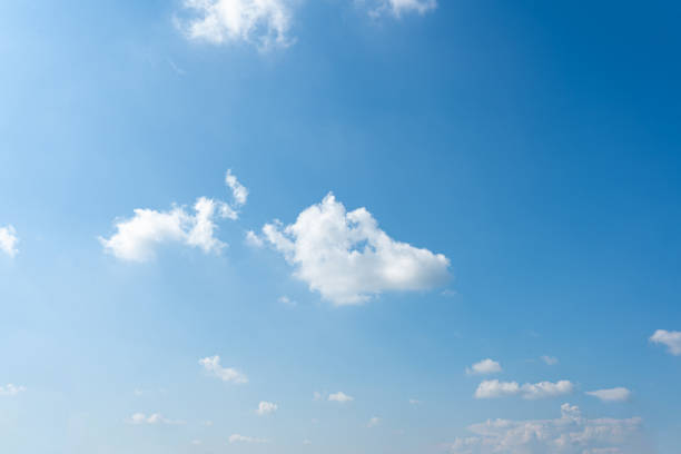 istock Fluffy white clouds drift across a clear blue sky, painting a breathtaking summer day 2176421897