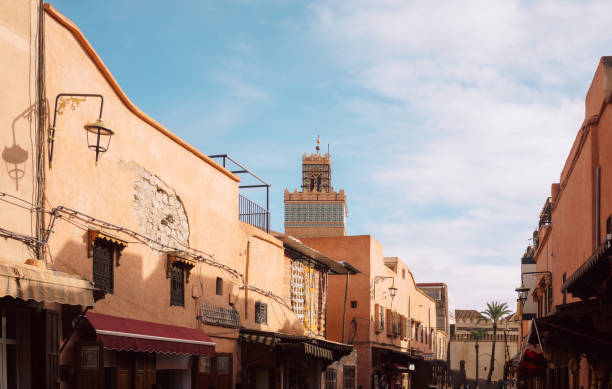 Moroccan riad courtyard showcasing traditional Islamic architecture with intricate carved cedarwood details, lush orange trees, and a serene garden