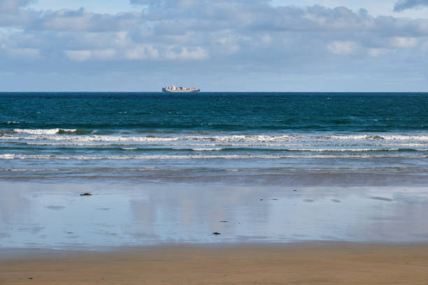 A container ship passes by the coast of Victoria - Ocean Grove, Victoria, Australia