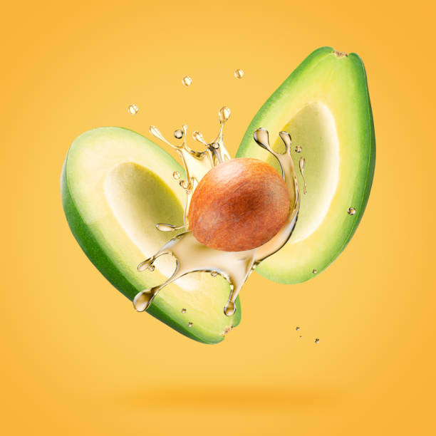 istock avocado with oil splash on a light green background 2176429387