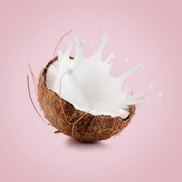 istock coconut with palm leaf and milk splash on a light pink background 2176430380