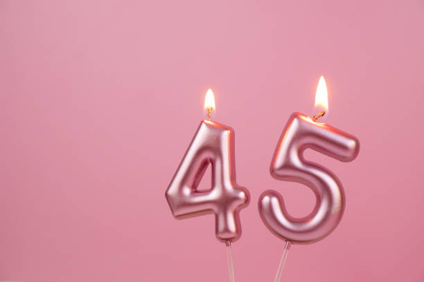 istock Pink birthday candles  on pink background, number 45 2176431209