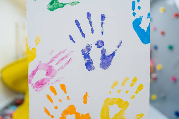 A background of colorful handprints in spray paint