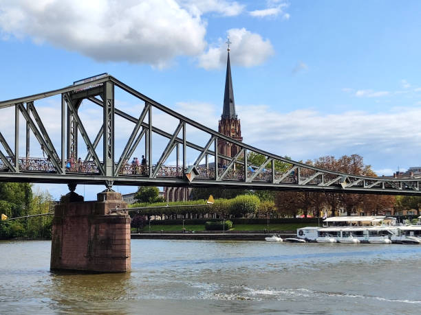 People walking on the Eiserner Steg (Iron Footbridge) which connects the centre of Frankfurt with the district of Sachsenhausen, Germany.