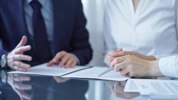 istock Diverse business people discussing contract terms before signing the agreement. Teamwork of lawyers and businesspeople 2176435919
