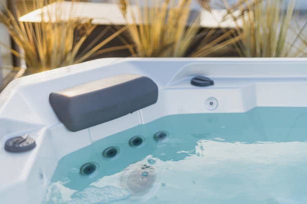 istock Modern bath with hydromassage jet, comfortable headrest and clear blue water in tub 2176435996