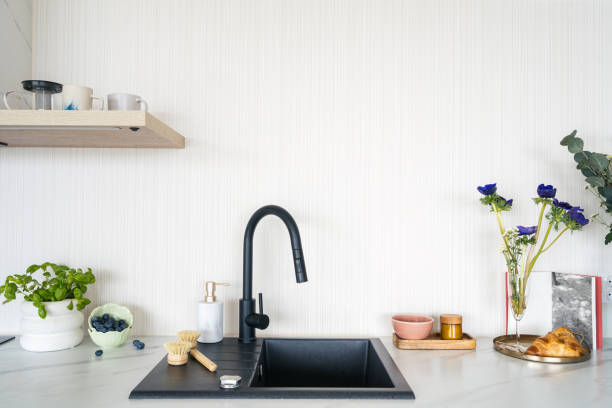 istock Modern kitchen sink with black faucet against white copy space wall 2176436039