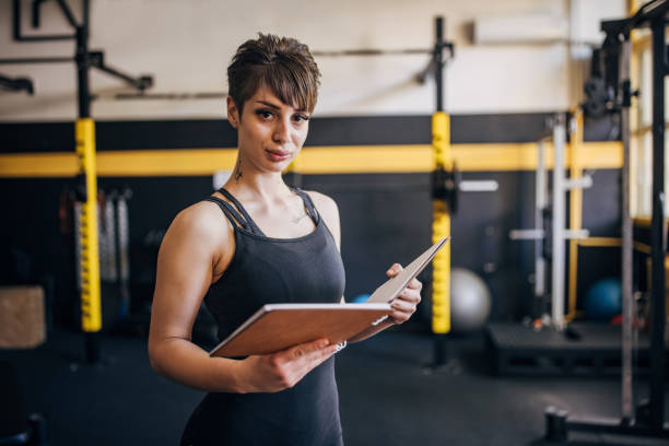 istock Confident woman reading notes in the gym setting. 2176436118