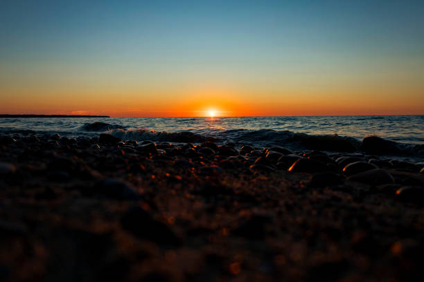 istock A beautiful sunset over the vast ocean with rocks in the foreground 2176437189