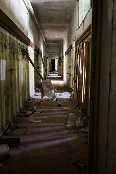 istock A long, dark hallway features a staircase positioned right in the middle of it 2176437288