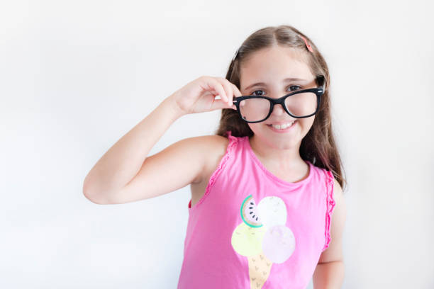 Portrait of a little schoolgirl looking away over white background