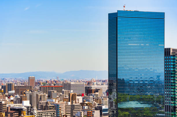 Modern glass skyscrapers in the business district of Osaka , Japan.