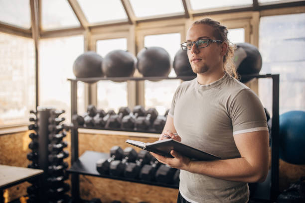 istock Gym coach reviews workout plan in preparation mode 2176446778