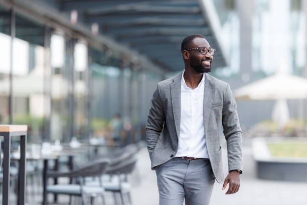istock Confident businessman walking outside modern office building 2176447470
