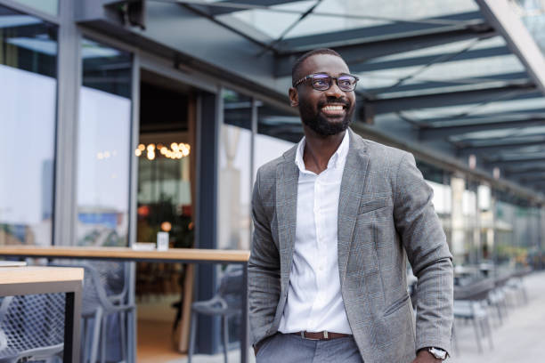 istock Confident businessman walking outside modern office building 2176447590