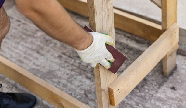istock Tools for sanding wood. Carpenter sanding wooden plank on table, closeup. Sanding wood with sandpaper. 2176447828
