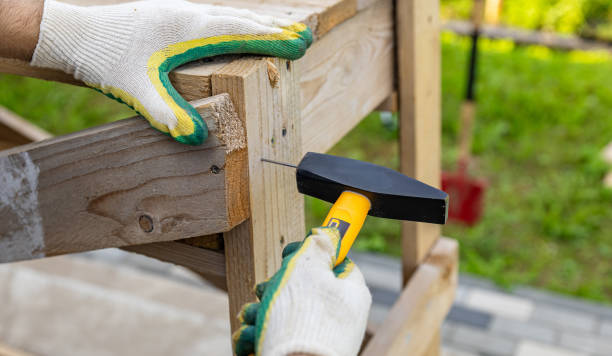 istock Close-up. Carpenter with hammer and nails fixes a wooden board. Construction industry, do it yourself. Wooden work table. 2176448569