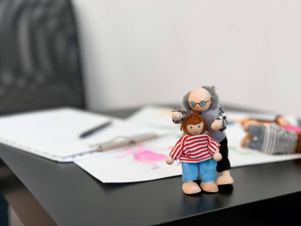 istock Colorful artistic dolls with sketches on desk background 2176451760