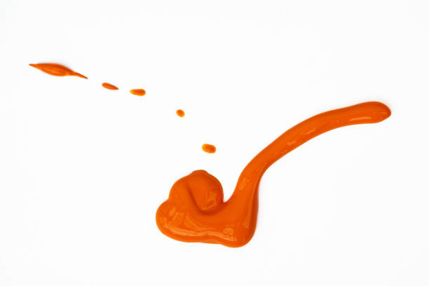 An orange colored blob of paint on a white background.