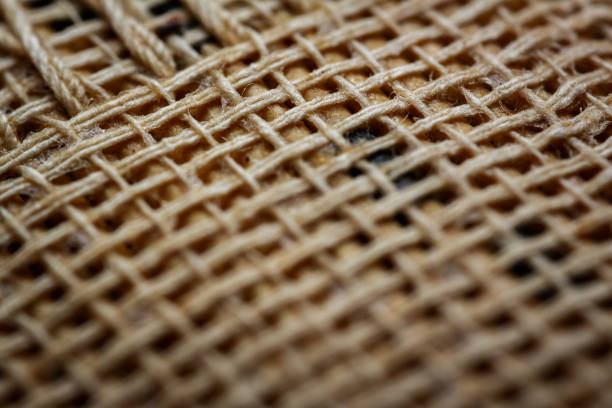Extreme closeup of an old book from the side. Selective soft focus, shallow depth of field. Bibliophile, bookworm abstract background. Book binding detail.