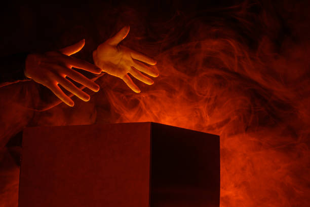Man opens magic box with surprise on dark background, mystical box, surprise, halloween, monster box