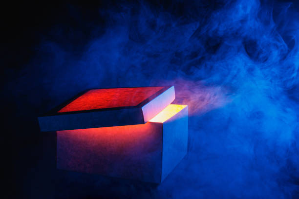 istock Man opens magic box with surprise on dark background, mystical box, surprise, halloween 2176458242