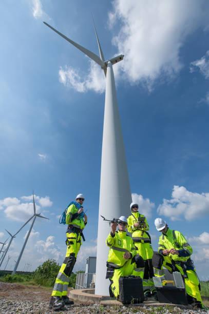 istock Wind Turbine Drone Inspection Maintenance and Repair Technician, Engineer team professional working maintenance clean power generator system 2176460065