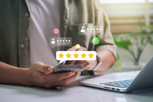 istock Customer Satisfaction, Digital interaction concept. person using a smartphone to leave a customer review, featuring various star ratings and feedback emoticons. 2176461181
