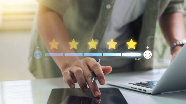istock Customer Satisfaction, Digital rating concept. person using a touchscreen to select a five-star rating on a digital feedback bar, showcasing customer satisfaction levels. 2176461288