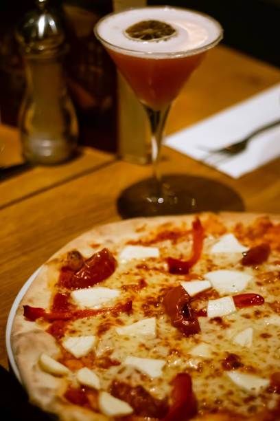 Goat cheese and red peppers Pizza and grapefruit margarita cocktail