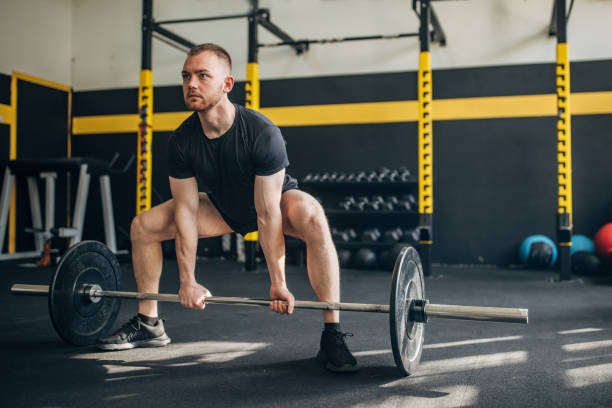 istock Focused athlete ready for deadlift in vibrant gym. 2176464115