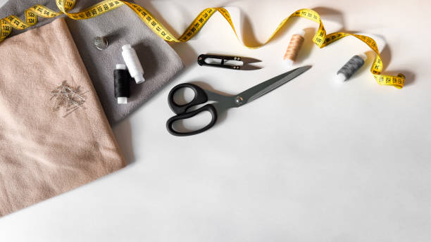 istock Sewing essentials flat lay with fabric, scissors, and measuring tape 2176468704