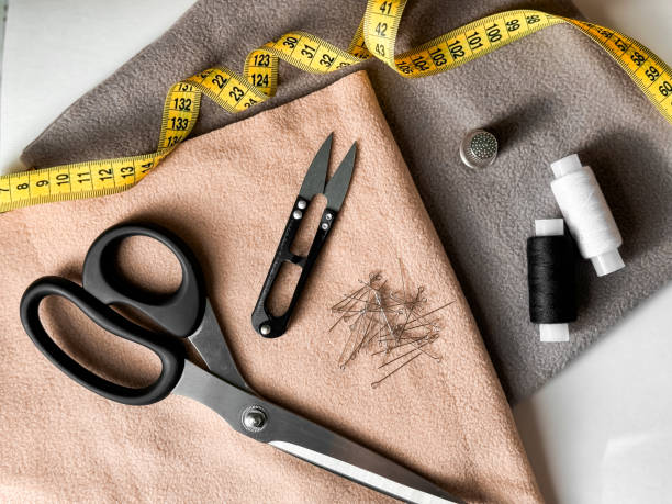 istock Sewing essentials. Tailoring tools with fabric, scissors, and measuring tape for creative projects 2176468711