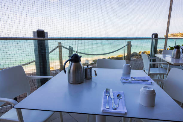 Outdoor dining area at beachfront restaurant in Aruba, with tables protected by netting to keep birds away.