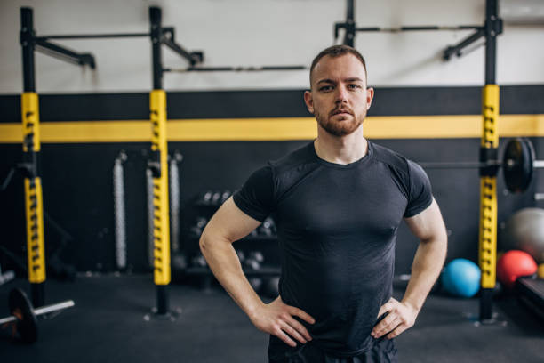 istock Serious man in black shirt inside a modern gym 2176473195