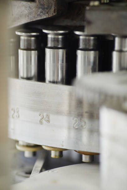 Close up on punch tools in tablet press machine for manufacturing pills at pharmaceutical factory, copy space